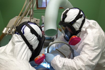 Matt Young, DDS. wears full body Haz-Mat protection in order to adhere to Occupational Safety (OSHA) regulations requiring him to protect himself and staff while working with mercury. The levels of mercury vapor released during the removal of an amalgam filling vastly exceed all established safety limits and those at which people are relocated from buildings.